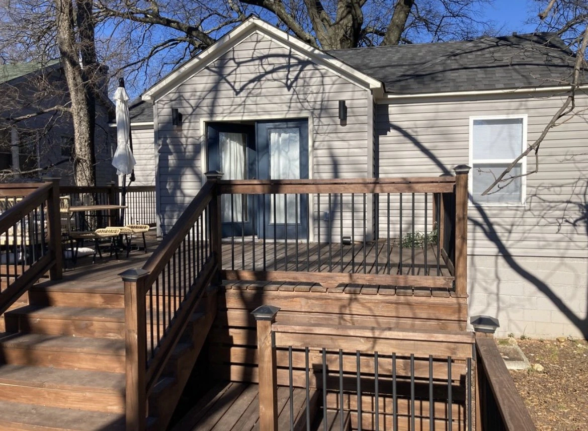 Finished deck, stairs and railing at the rear of a home
